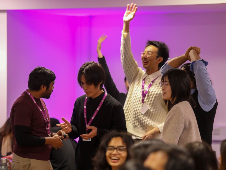 Students talking and having fun, one student raising his hand